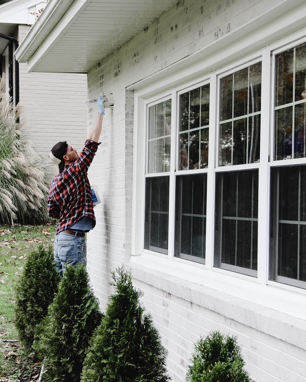 Painter applying Classico Limewash to home exterior